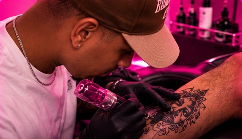 Close-up of a tattoo artist creating a custom tattoo on a client's arm